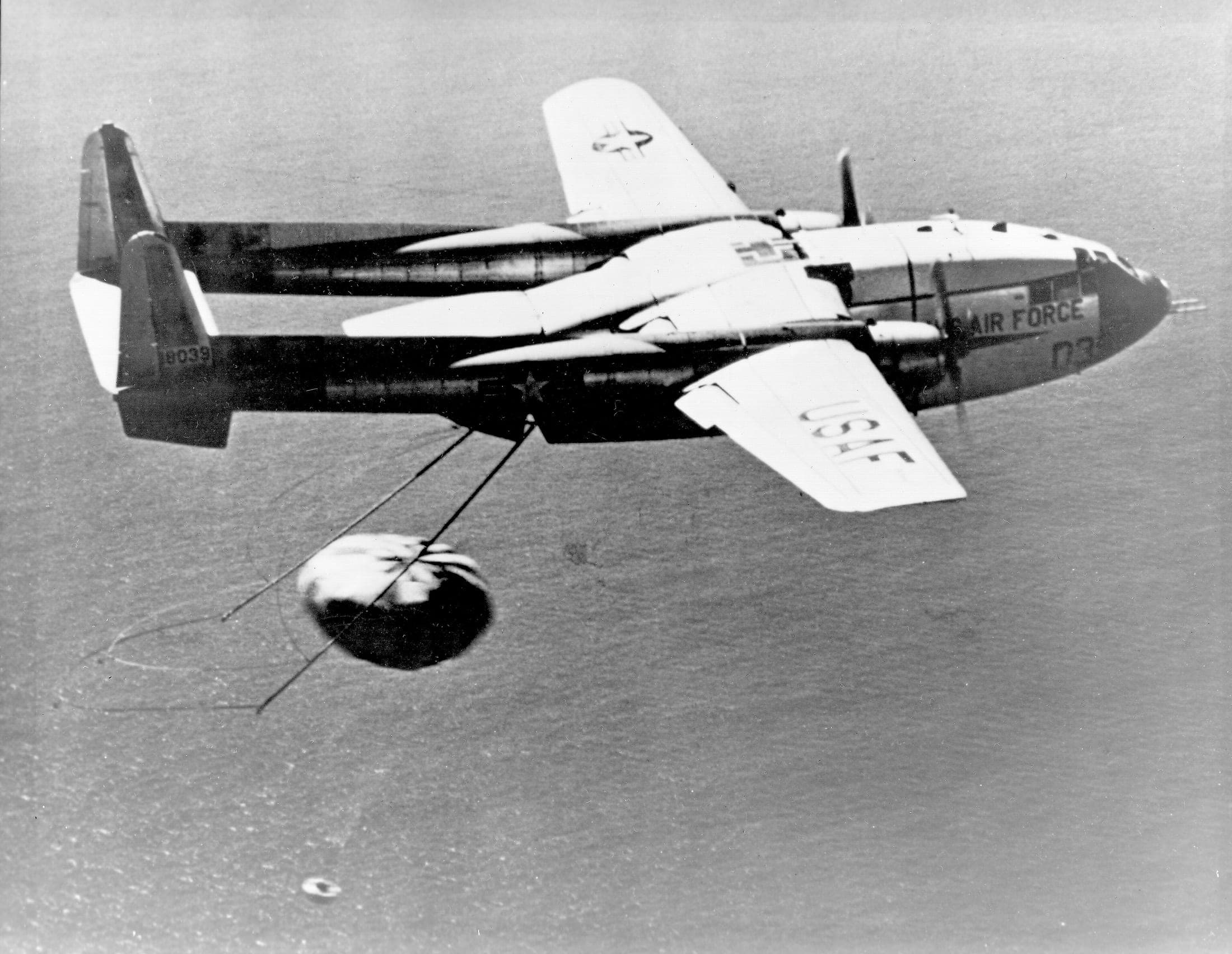 U.S. Air Force C-119J snagging a returning CORONA film capsule's parachute in mid-air